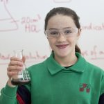 TEMS student holding glass beaker