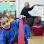 TEMS student playing with pink blocks
