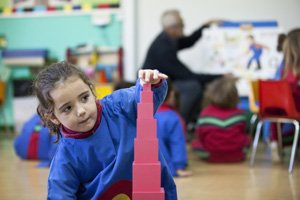 TEMS student playing with pink blocks